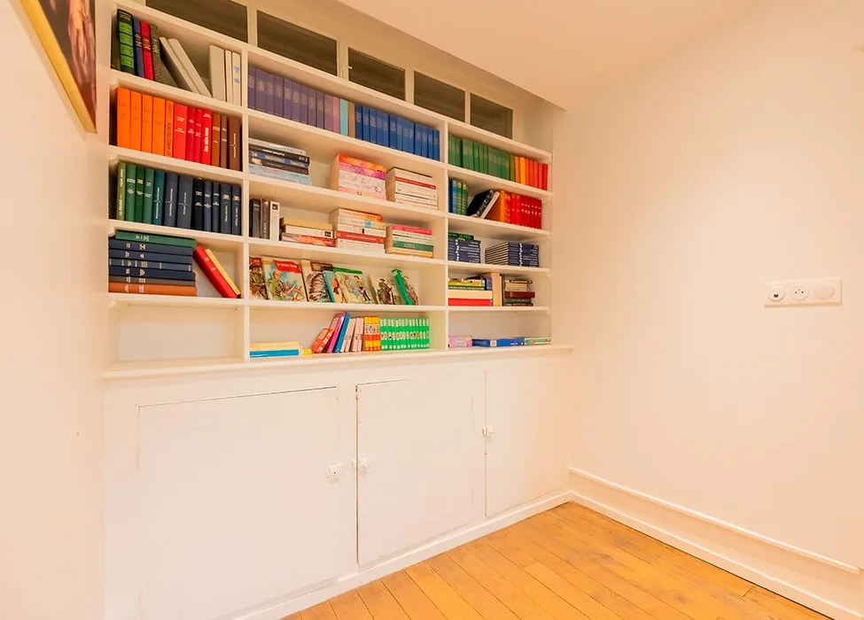 Bibliothèque garnie de livres dans un coin salon cosy