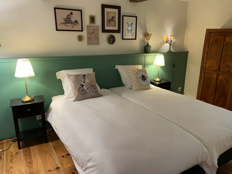 Chambre douillette avec tête de lit capitonnée et coussins colorés