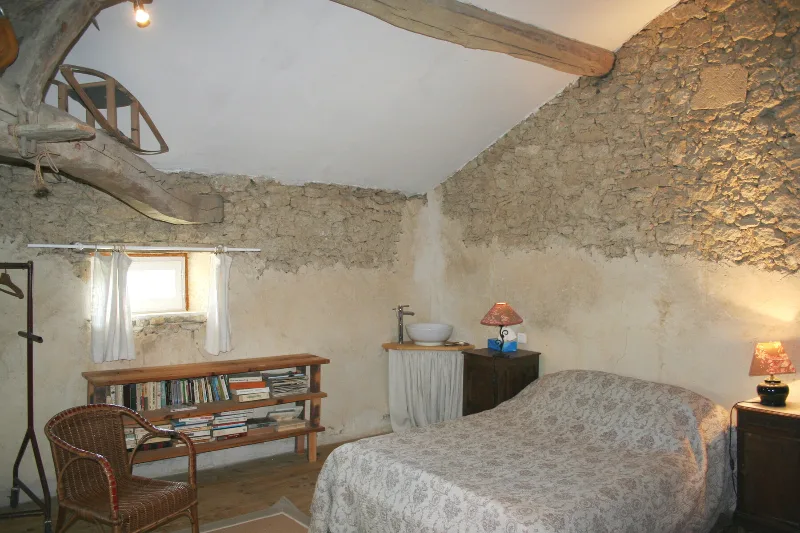 Chambre des parents lumineuse avec grand lit et mobilier ancien