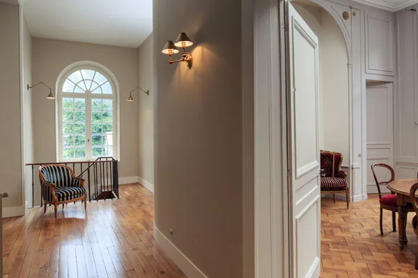 Couloir de l'étage avec fenêtre cintrée et parquet ancien