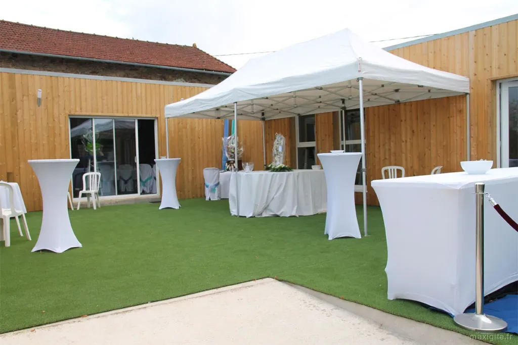 Terrasse de réception aménagée avec tente blanche, mange-debout et espace cocktail