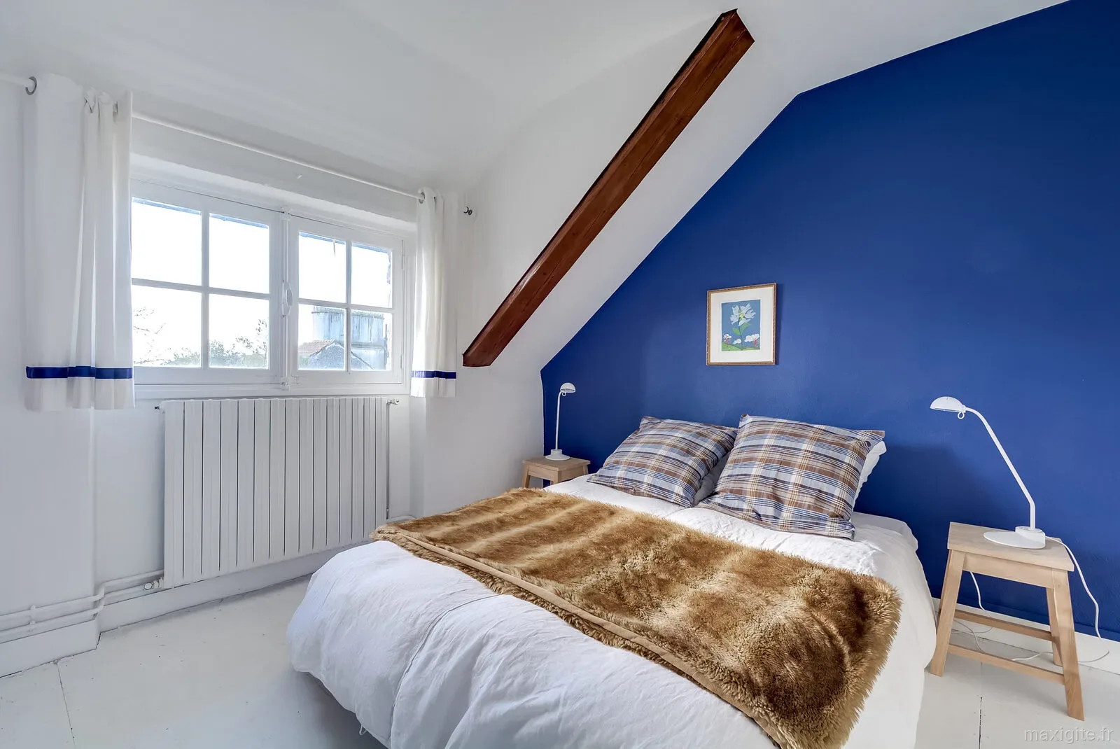 Chambre lumineuse avec lits et décoration simple