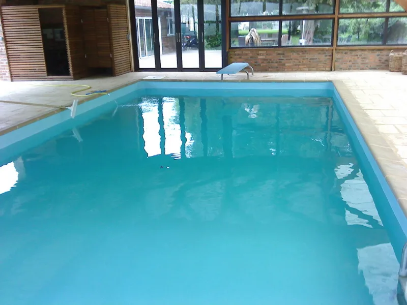 Piscine couverte chauffée avec plage carrelée et sauna attenant