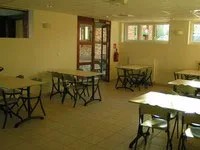 Seconde salle de restauration lumineuse avec tables individuelles