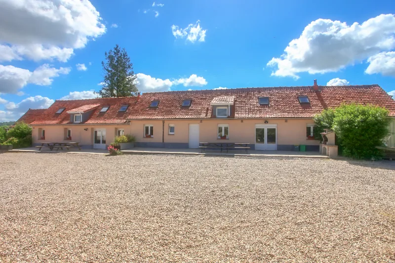 Façade des trois gîtes mitoyens avec terrasse et tables de pique-nique