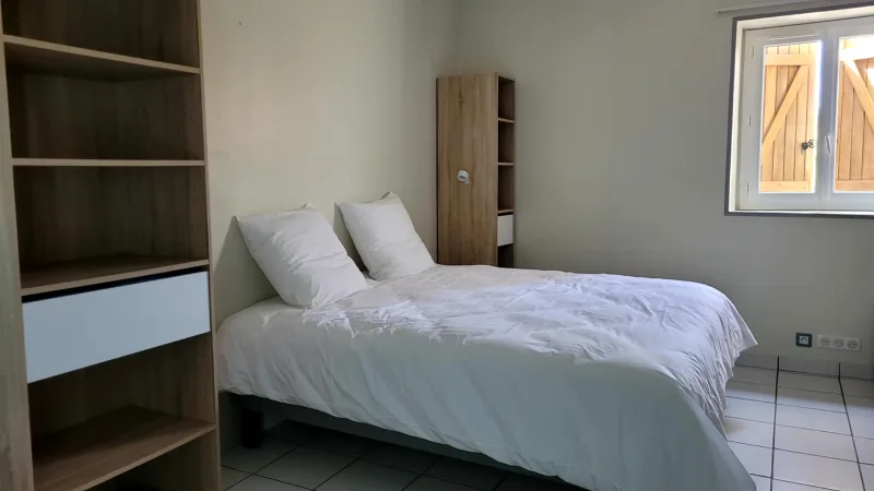 Chambre familiale lumineuse avec lit double et rangements en bois clair