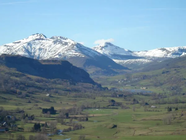 Vue panoramique sur les monts du Cantal enneigés depuis les alentours du gîte